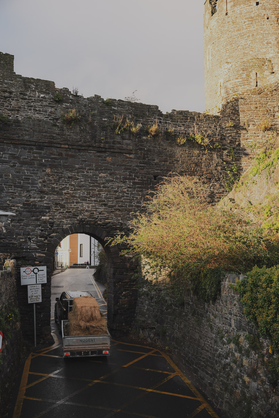 Car passing through Conwy Castle